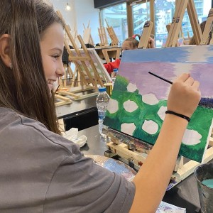 Art therapy for children with colorful paint and a brush in hand